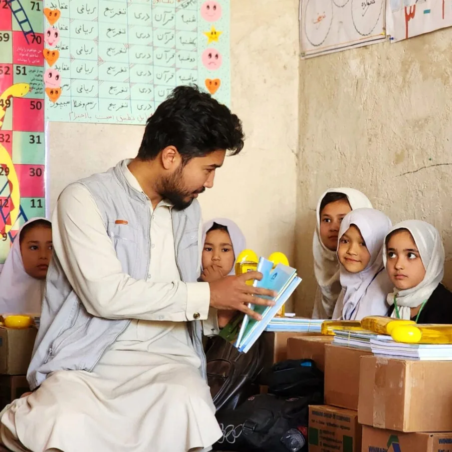 Afghan girls receiving school supplies through a Gate of Hope education program